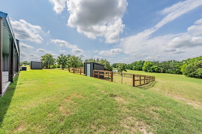 View of yard featuring an outdoor structure and a rural view | Image 15