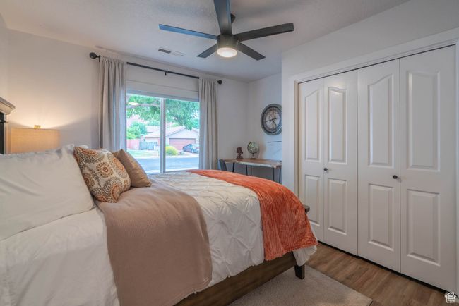 Bedroom with ceiling fan, access to exterior, hardwood / wood-style floors, and a closet | Image 38