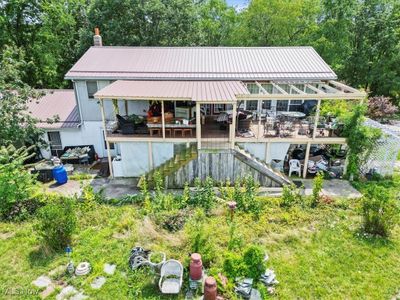 Rear view of house with a deck and a patio area | Image 3