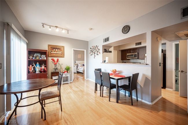 Dining area featuring light wood-style floors and visible vents | Image 9