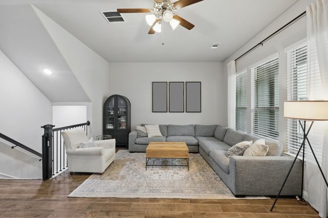 Living area with visible vents, wood finished floors, and ceiling fan | Image 16