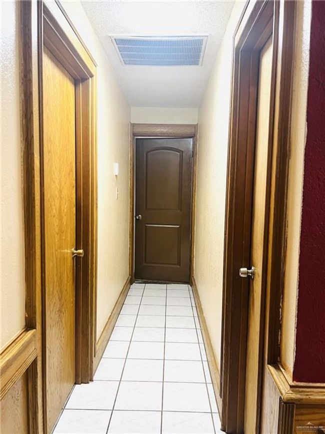Hallway with light tile patterned floors | Image 11