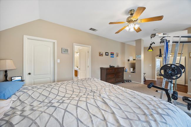 Carpeted bedroom featuring lofted ceiling and a ceiling fan | Image 27