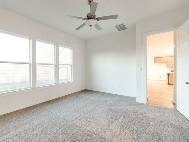 Empty room with light colored carpet and a ceiling fan | Image 29