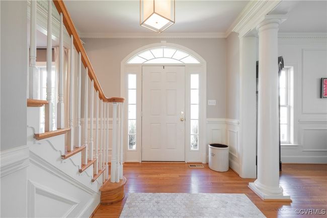 Entryway featuring visible vents, a wealth of natural light, and decorative columns | Image 7