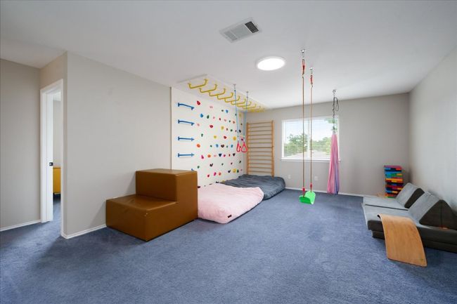 Large loft offers custom rock climbing wall, ceiling bars and swings! | Image 34