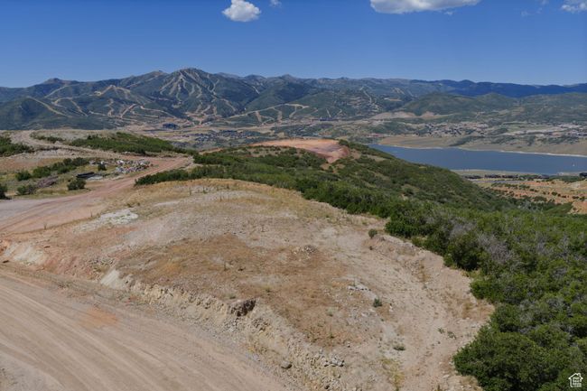View of mountain background with a large body of water | Image 11