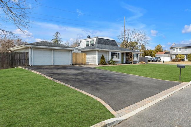 View of front of house featuring a front yard, an outdoor structure, fence, and roof with shingles | Image 20