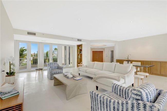 A gallery of French doors leads to the covered west balcony offering an abundance of afternoon sun and sunsets! | Image 8