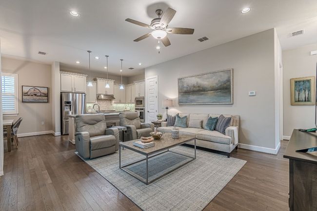 Living room with a ceiling fan, dark wood finished floors, baseboards, and recessed lighting | Image 8