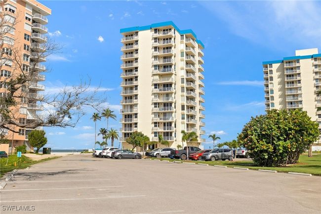 View of apartment building / complex with uncovered parking | Image 26