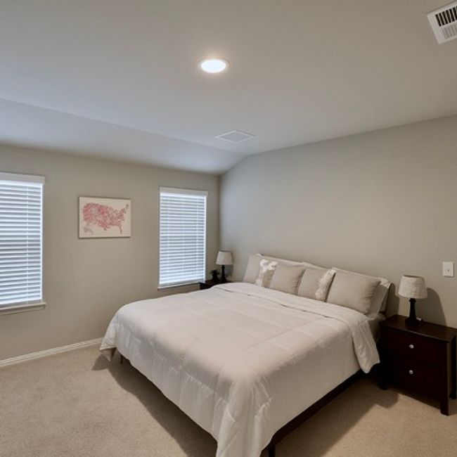 Bedroom featuring light colored carpet, lofted ceiling, and recessed lighting | Image 7