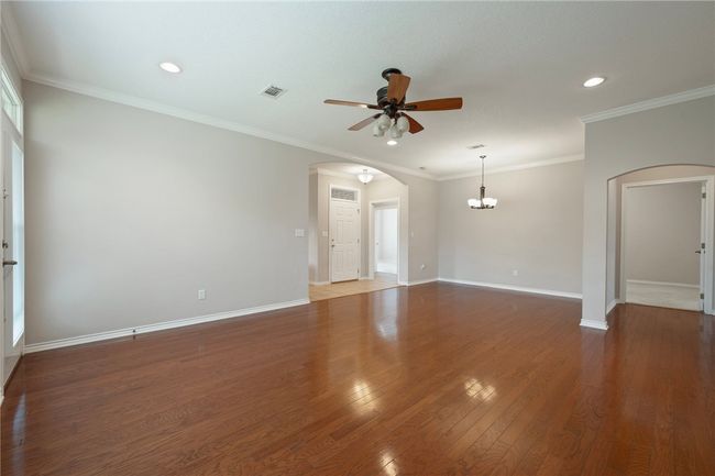 Unfurnished room with arched walkways, ceiling fan, baseboards, recessed lighting, and wood finished floors | Image 23
