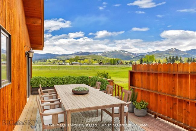 This image has been virtually staged. Deck off of dining room | Image 7