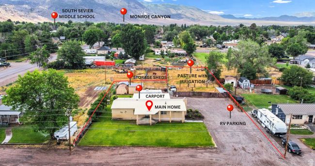 Aerial view of property and surrounding area with a mountain backdrop and property parcel outlined | Image 35