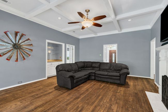 Living room with coffered ceiling, ceiling fan, wood finished floors, recessed lighting, and beamed ceiling | Image 10