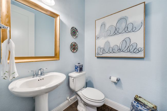Guest bath with framed mirror, pedestal sink and upgraded flooring. | Image 22