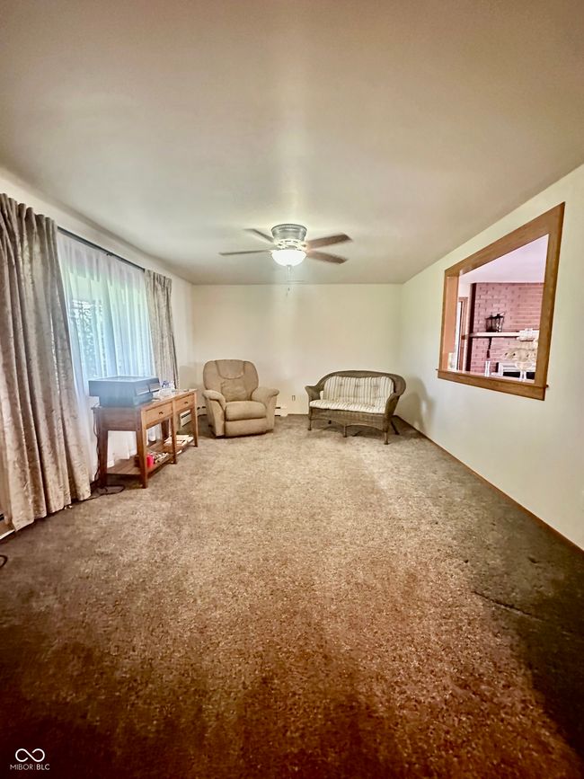 sitting room with carpet and ceiling fan | Image 20