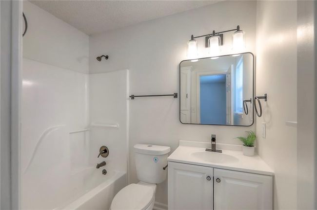Full bath featuring vanity, shower / bathtub combination, and a textured ceiling | Image 12