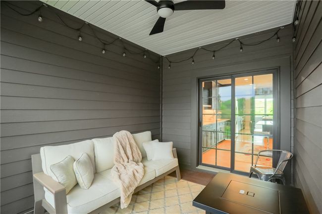 The large dining area flows seamlessly on to the private covered patio. Access to the office area with French doors and the hallway leading to the powder room and storage closet are found in this space. | Image 14