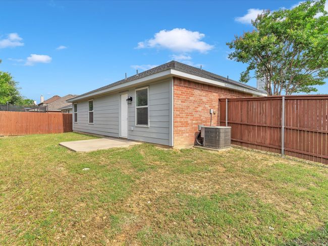 Back of property featuring central air condition unit, brick siding, a patio, and a shingled roof | Image 27