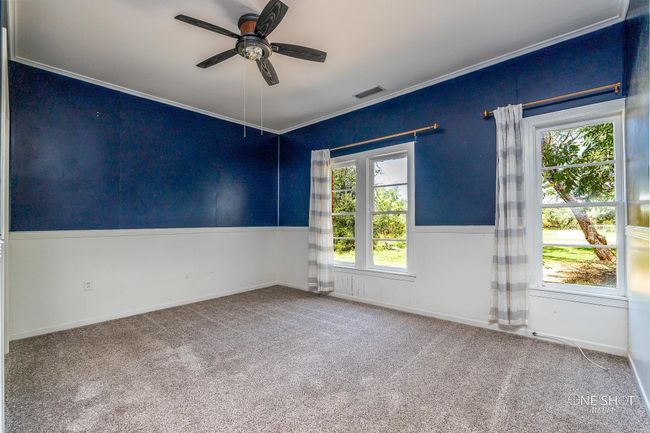 Empty room with ornamental molding, ceiling fan, and carpet floors | Image 21