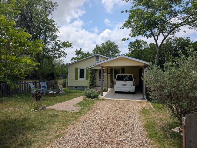 Bungalow featuring wide driveway and carport. | Image 34