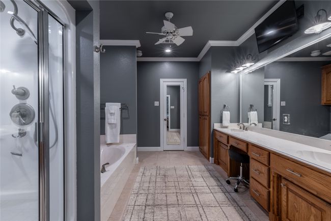 Second primary bathroom with ornamental molding, a whirlpool tub, a shower stall, tile floors, and recessed lighting | Image 25