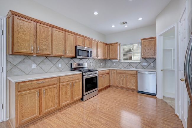Kitchen has plenty of cabinets & storage | Image 10