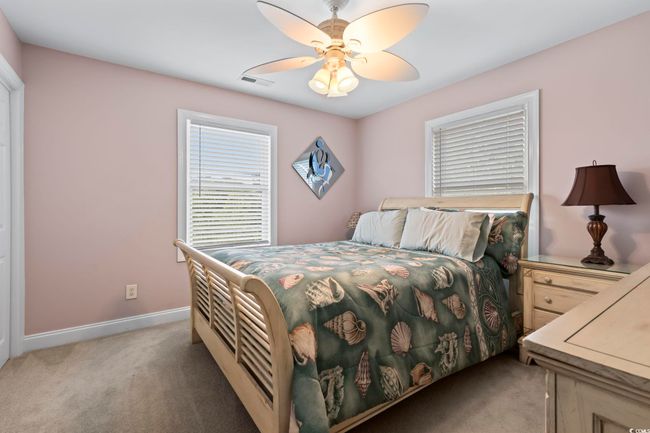 Bedroom featuring light colored carpet, baseboards, and a ceiling fan | Image 28