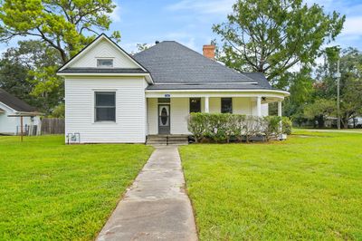 This Victorian inspired home boasts an abundance of southern charm thanks to the stacked roof detail and wrap around porch. While this home was built in the 1920’s, it has been loved and cared for by only one owner, making this a rare gem. | Image 1