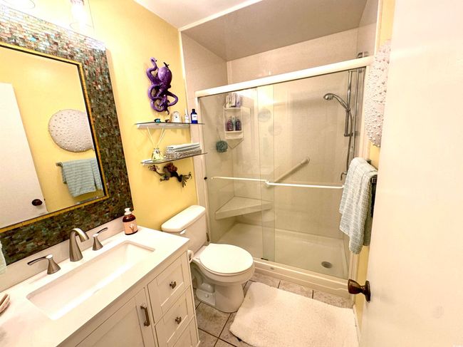 Bathroom featuring tile patterned floors, a stall shower, and vanity | Image 26