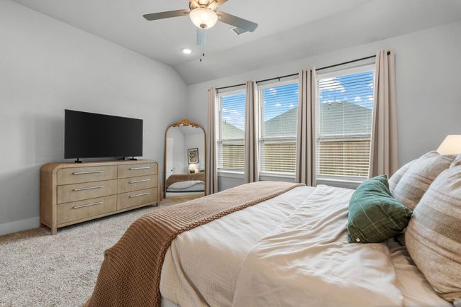 Bedroom with light carpet, a ceiling fan, lofted ceiling, and recessed lighting | Image 24