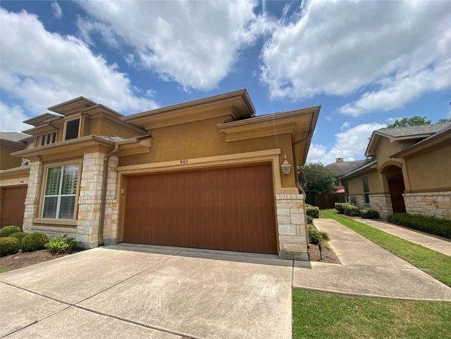 Prairie-style home featuring stone siding, concrete driveway, an attached garage, and stucco siding | Image 40