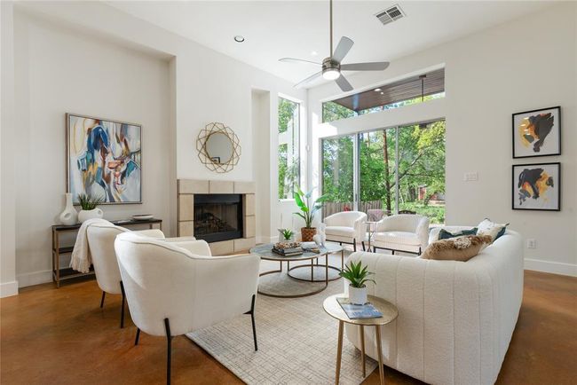 Living area featuring baseboards, a fireplace, concrete flooring, ceiling fan, and recessed lighting | Image 10