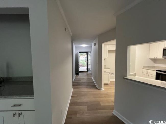 Hall with baseboards, ornamental molding, and wood finished floors | Image 38