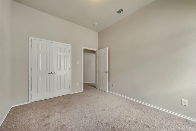 Unfurnished bedroom with carpet floors, high vaulted ceiling, and a closet | Image 30