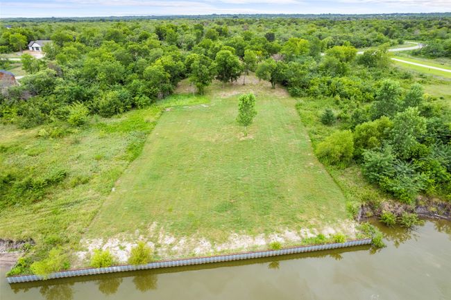 Aerial view of a nearby body of water and a heavily wooded area | Image 14