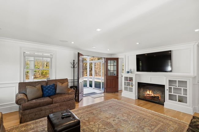 Living room with light hardwood / wood-style flooring and ornamental molding | Image 16