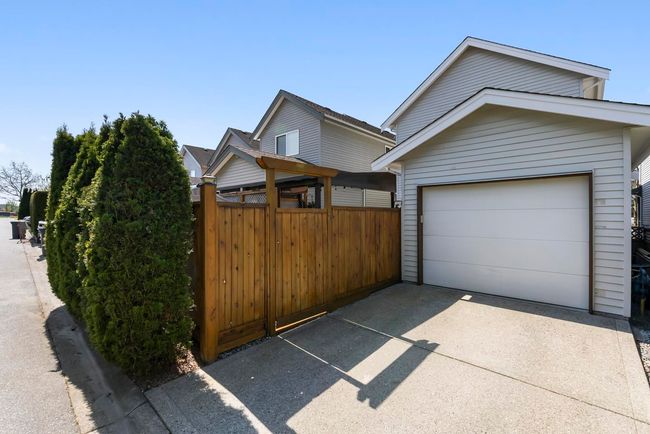 Exterior space featuring a garage, driveway, and fence | Image 37