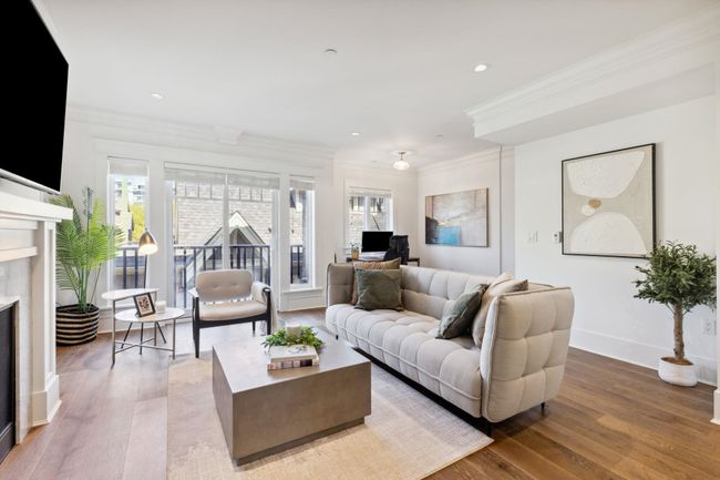 Living area featuring a premium fireplace, wood finished floors, crown molding, and baseboards | Image 6