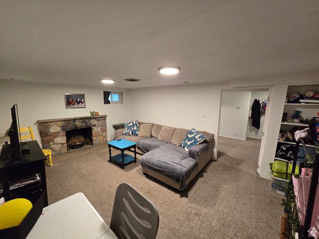 Living area featuring visible vents, a fireplace, and carpet flooring | Image 32