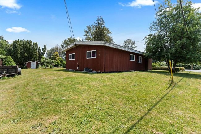 View of property exterior with a yard and a shed | Image 6