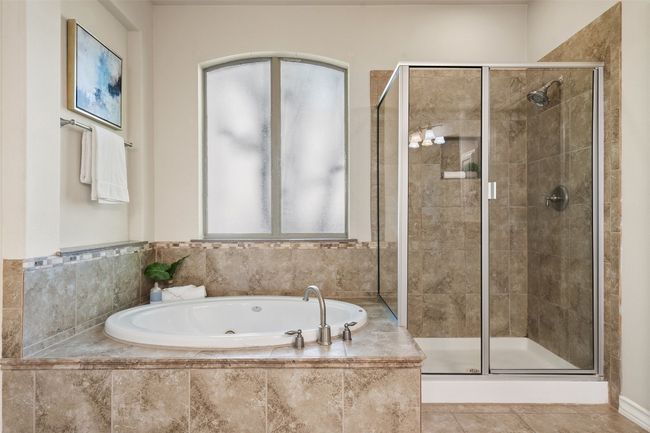 Grab some me-time in the spacious tub and walk-in shower. | Image 27