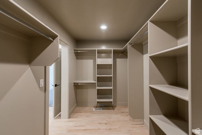 Walk in closet with light wood-style flooring | Image 18