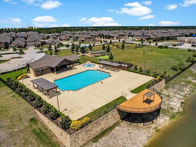 Community pool with a residential view and a hot tub | Image 19