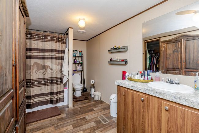 Bathroom with vanity, curtained shower, crown molding, toilet, and wood finished floors | Image 20