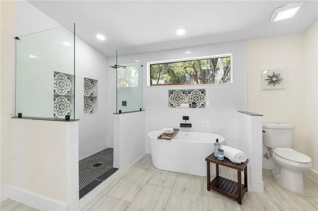 The en-suite also includes a dreamy freestanding soaking tub and a massive frameless walk-in shower. | Image 20