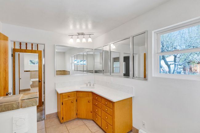 Full bathroom featuring tiled shower and toilet | Image 15