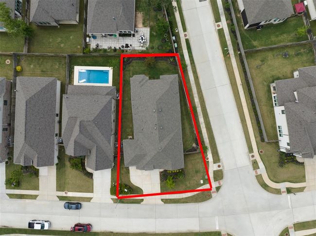 Spacious driveway with a three-car garage for ample parking and storage. | Image 45